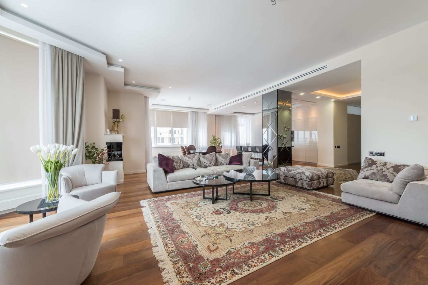Elegant penthouse living room with hardwood floors and skyline light